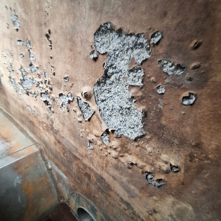 This sludge thickener tank had an epoxy coating applied which is now blistering and peeling due to biogenic corrosion